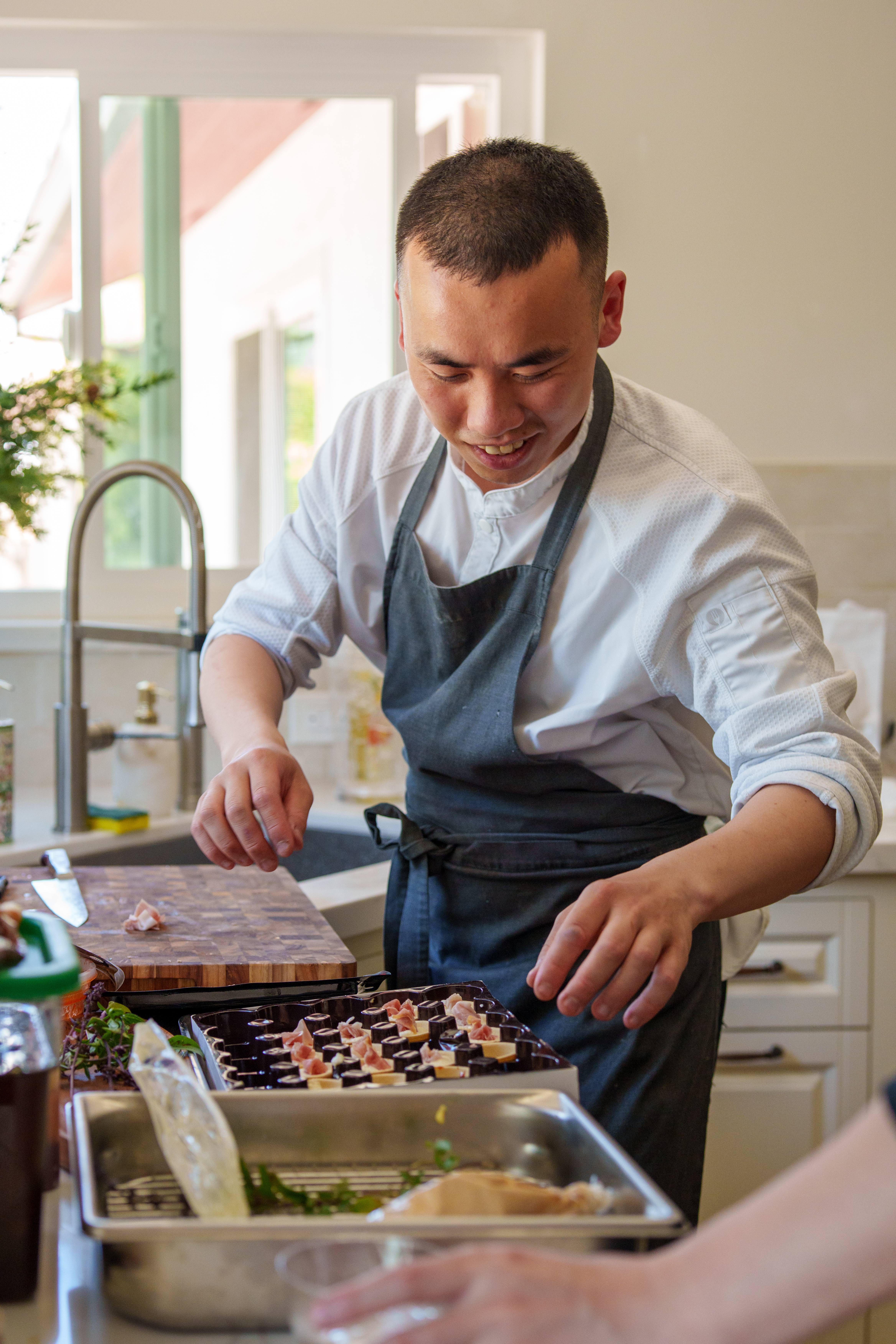 Chef Desmond plating canapés at the kitchen counter