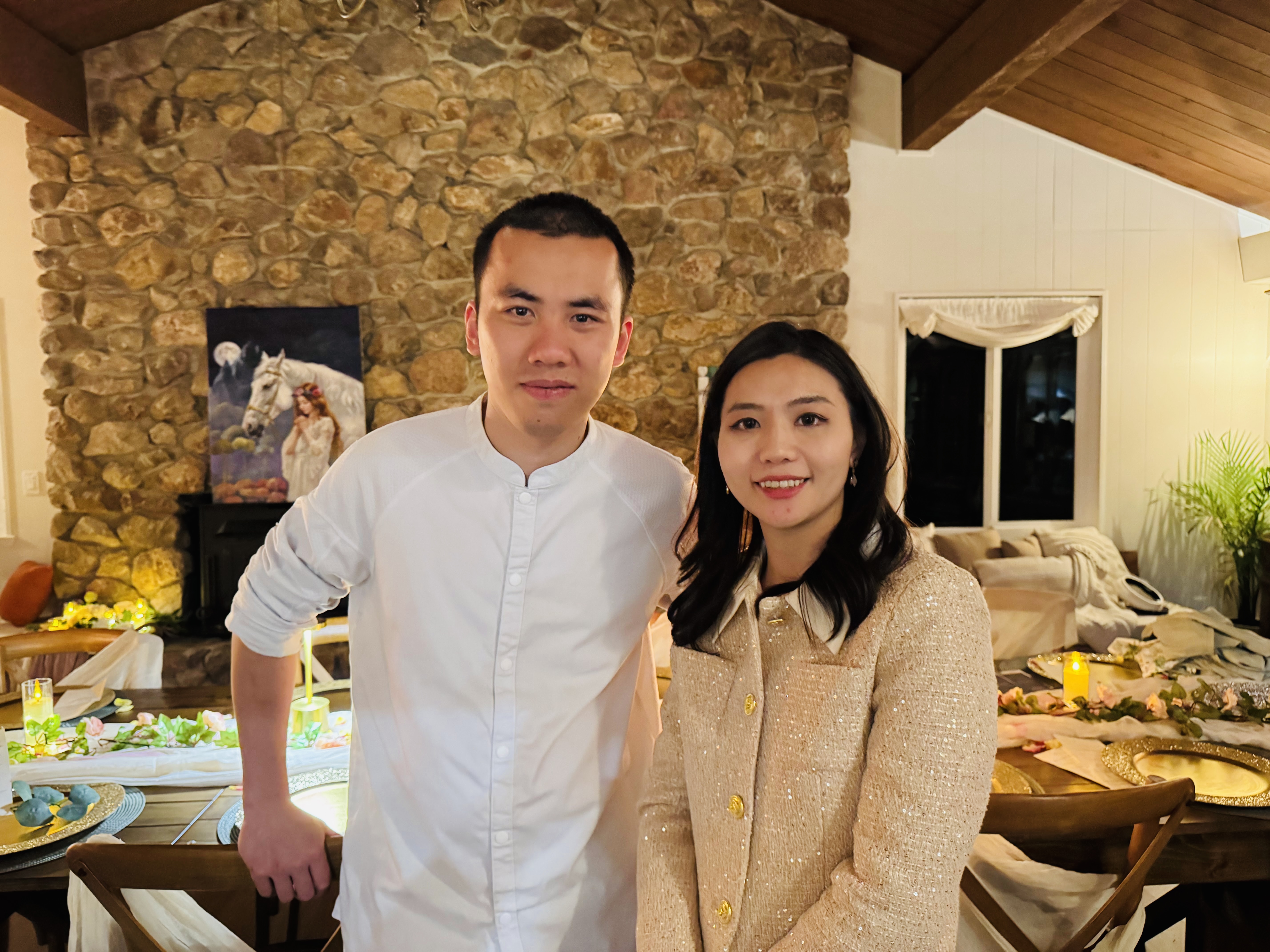 Chef Desmond Ho with the evening's host, standing in front of the stone hearth