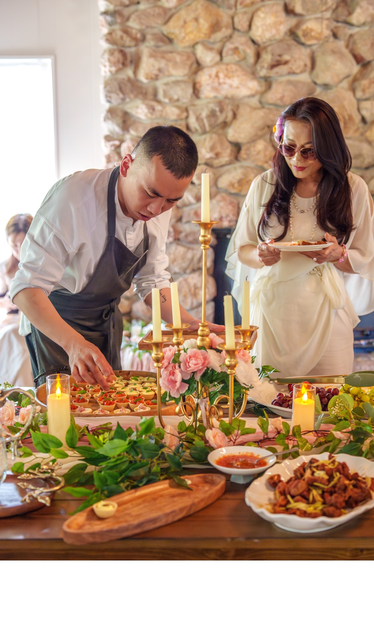 Chef Desmond Ho in conversation with a senior guest at the table
