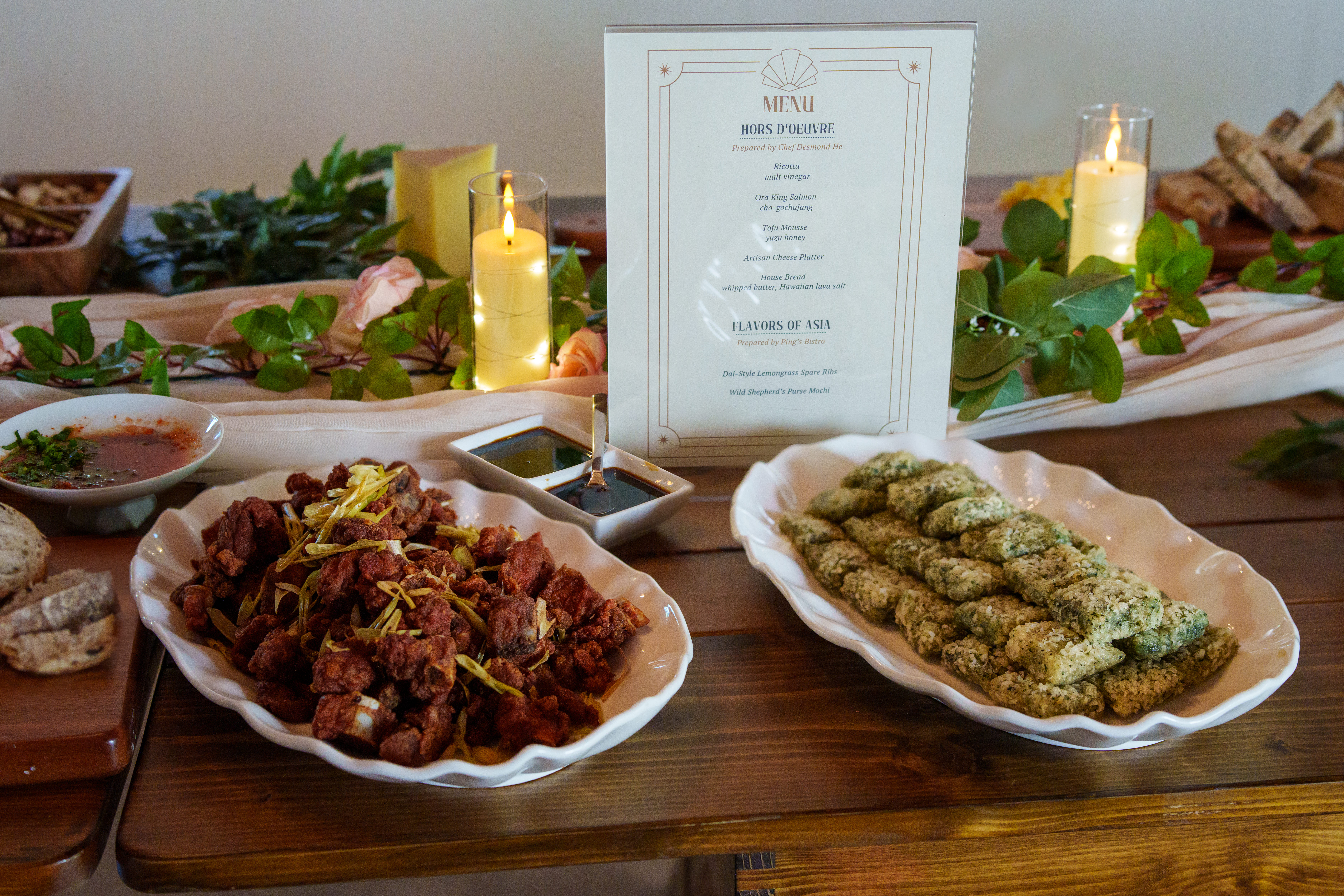 Detail of the curated grazing table with cheeses, breads, fruits, and floral garlands
