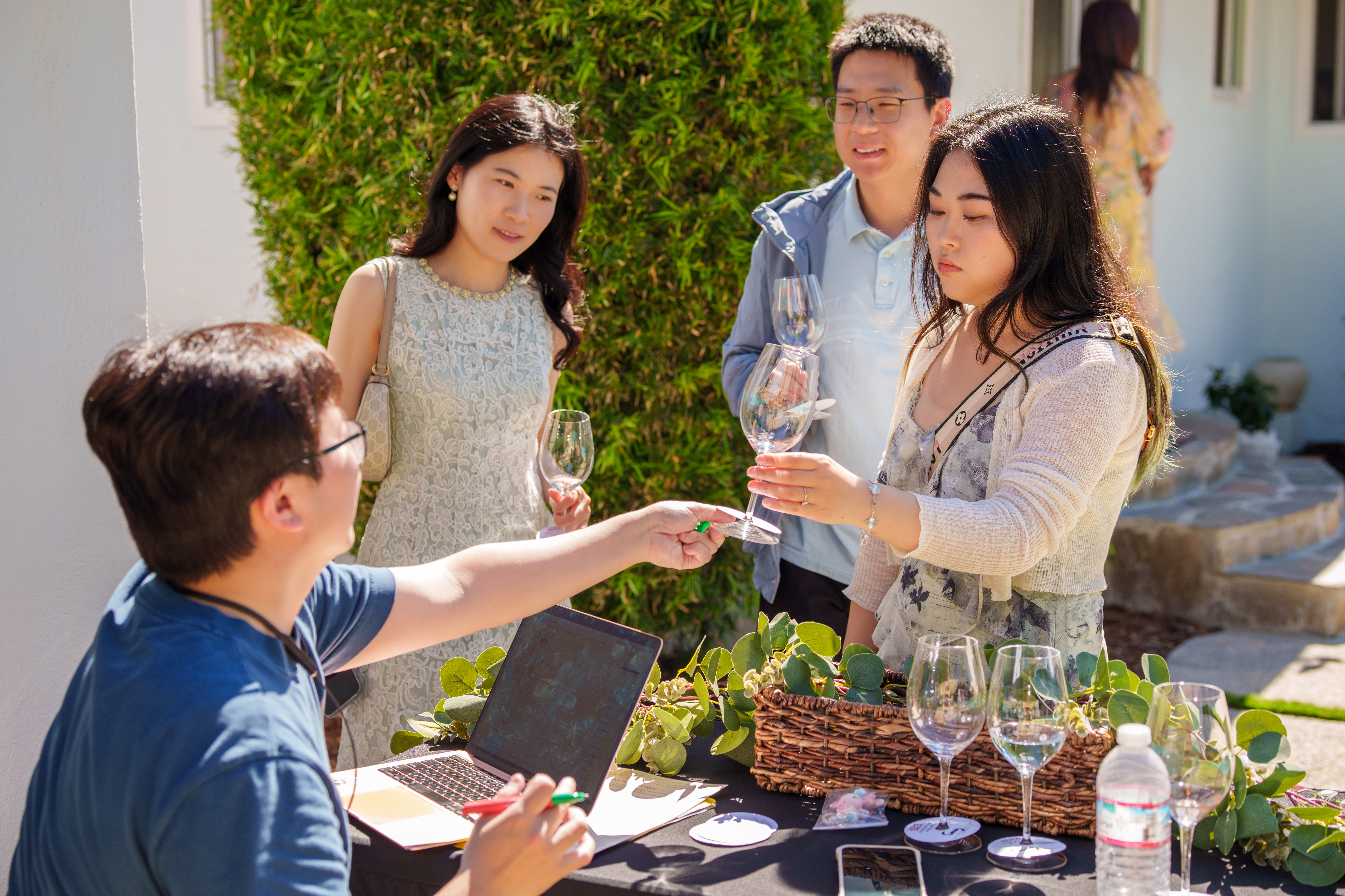 A flight of red wines poured in glasses awaiting tasting